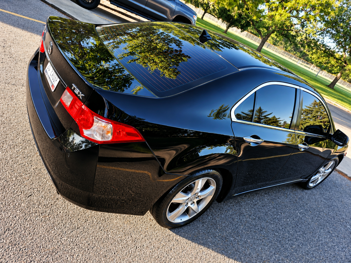 Black Acura with a freshly detailed rear quarter and deep gloss